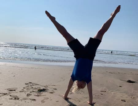 Child doing a cartwheel on the beach